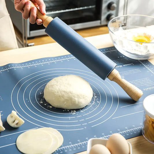 Professional rubber wood rolling pin and large green silicone non-stick pastry mat for rolling dough and baking.